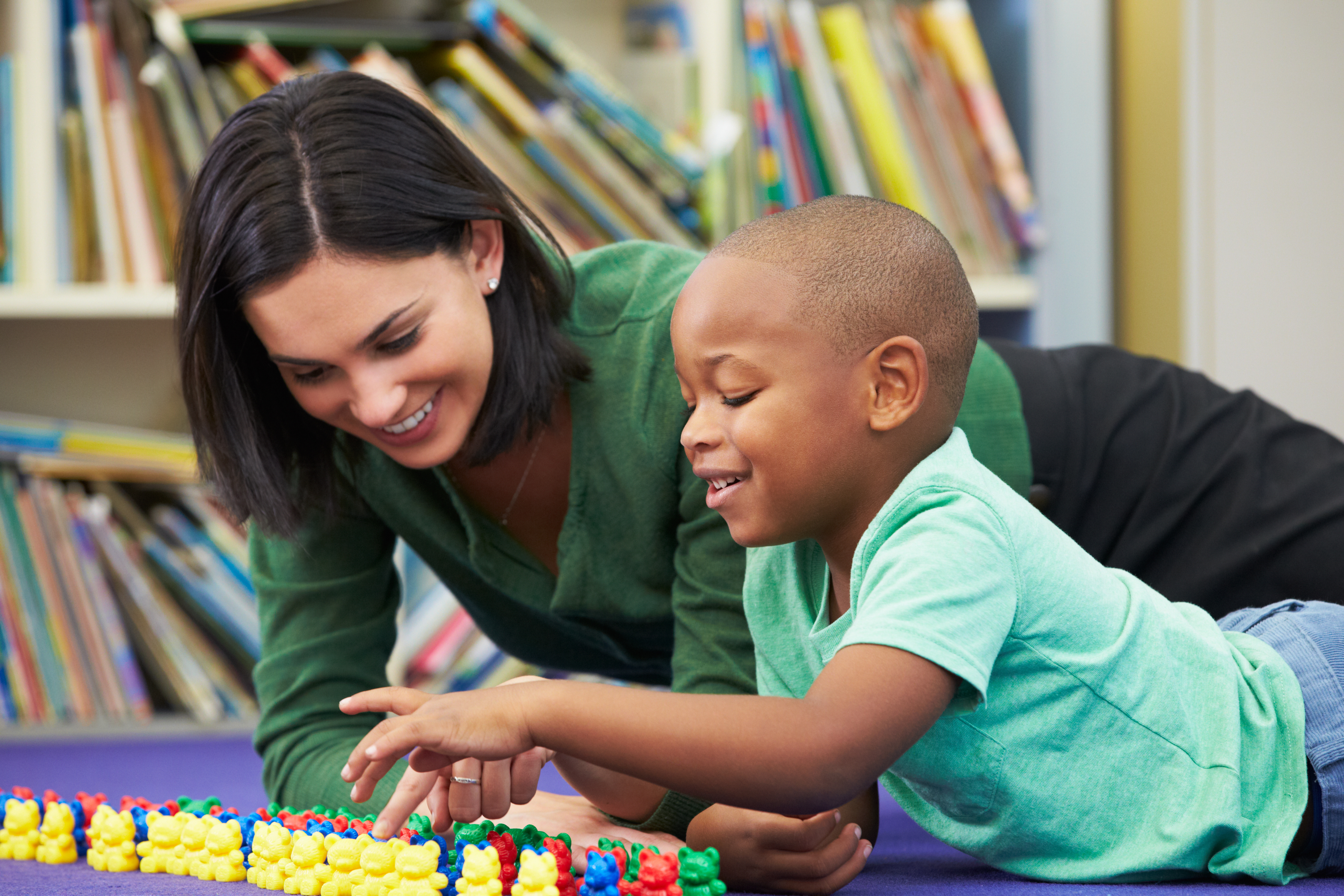 Elementary Pupil Counting With Teacher In Classroom