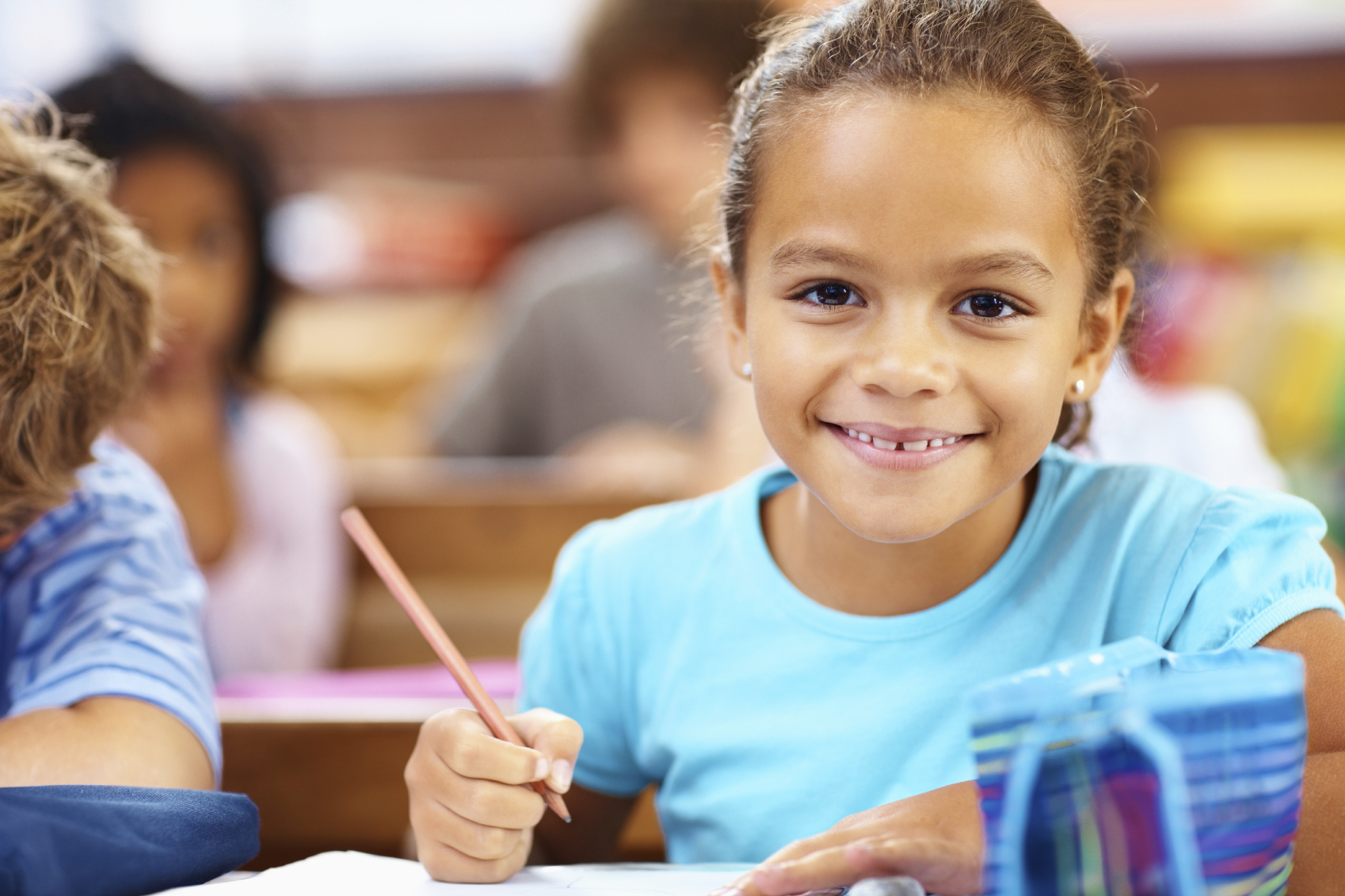 Cute small girl at elementary school, classroom view